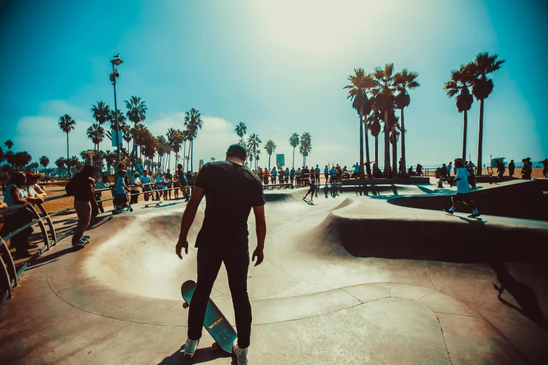 a man riding a skateboard up the side of a ramp, pexels contest winner, with palm trees in the back, people in beach, harriet tubman skateboarding, los angelos