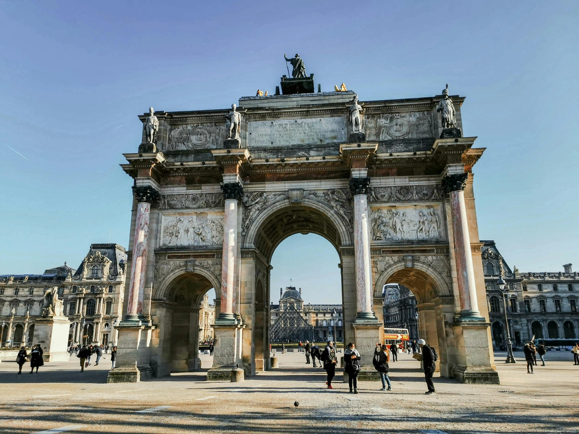 a group of people that are standing in front of a building, archway, ornate french architecture, 🚿🗝📝, square