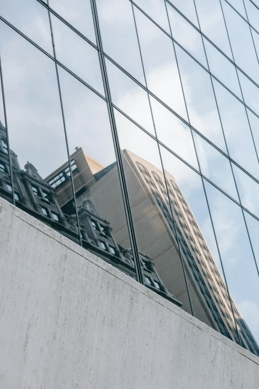 a building is reflected in the windows of another building, inspired by Richard Wilson, unsplash, zoomed in, cityscape, concrete steel glass, buttresses