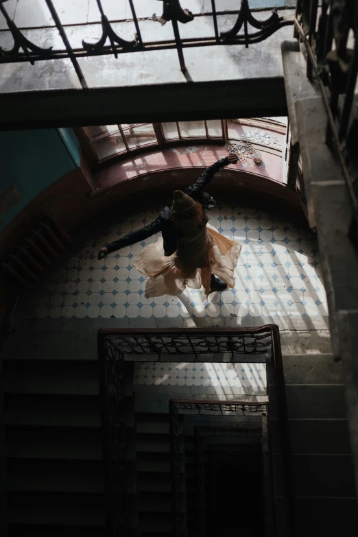 a woman walking down a flight of stairs, inspired by Luis Paret y Alcazar, pexels contest winner, arabesque, mid air shot, cinestill, ignant, mexico