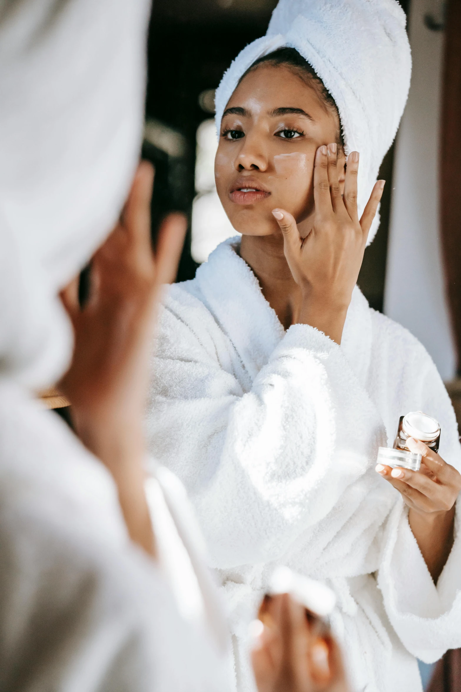 a woman that is standing in front of a mirror, wearing a white robe, smooth facial features, manuka, thumbnail