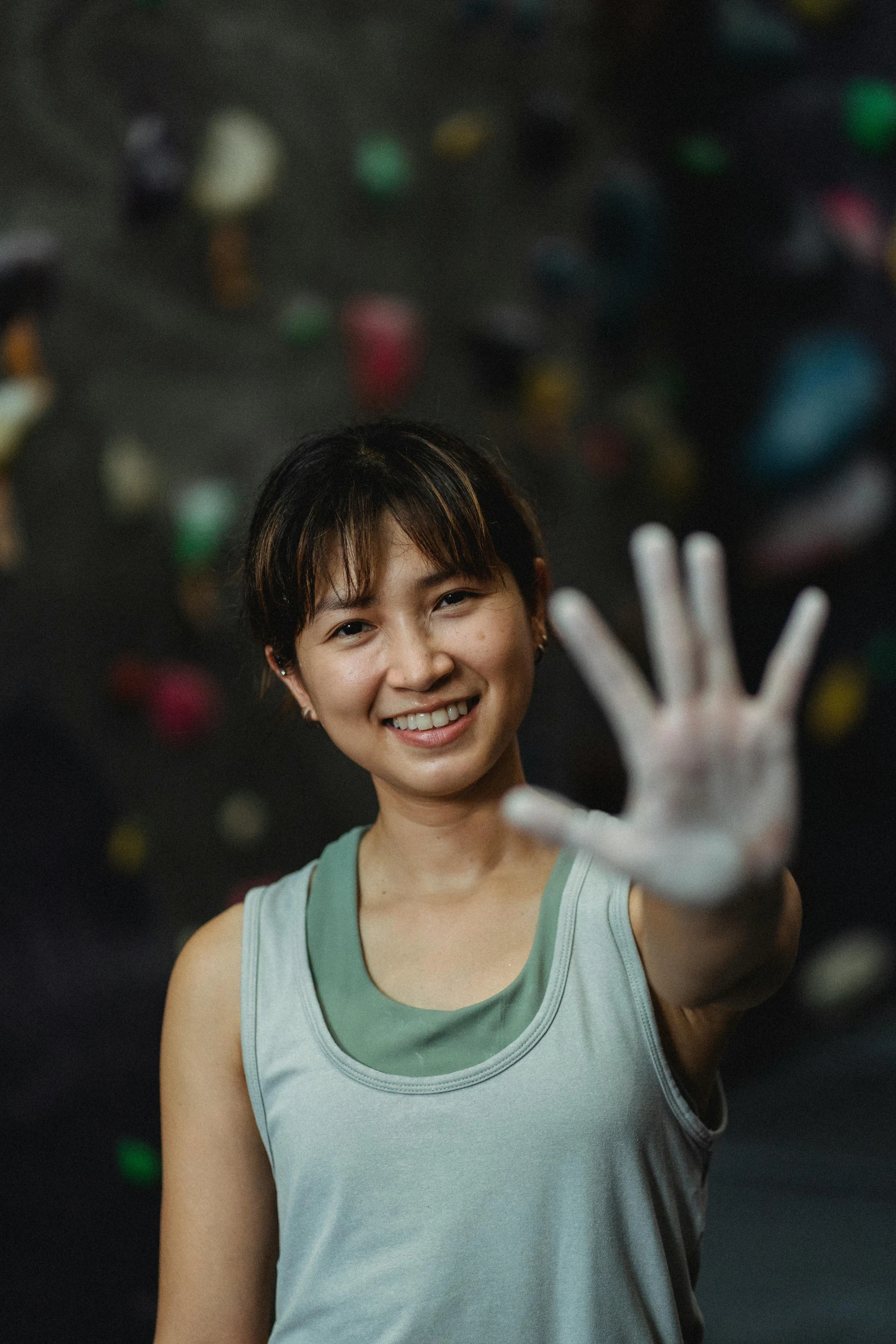 a woman standing in front of a climbing wall, a portrait, inspired by helen huang, pexels contest winner, gutai group, hands with five fingers, avatar image, in a gym, vietnamese woman