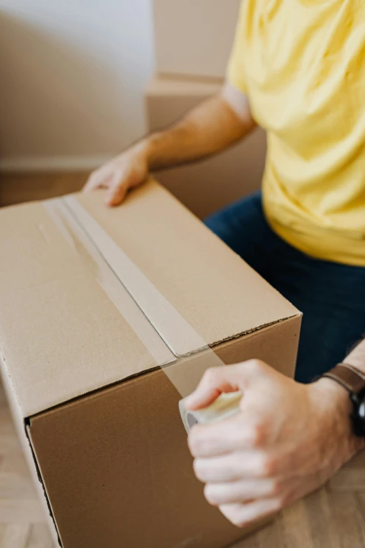 a man sitting on the floor holding a box, pexels contest winner, hurufiyya, opening, sydney, ebay listing thumbnail, used tape