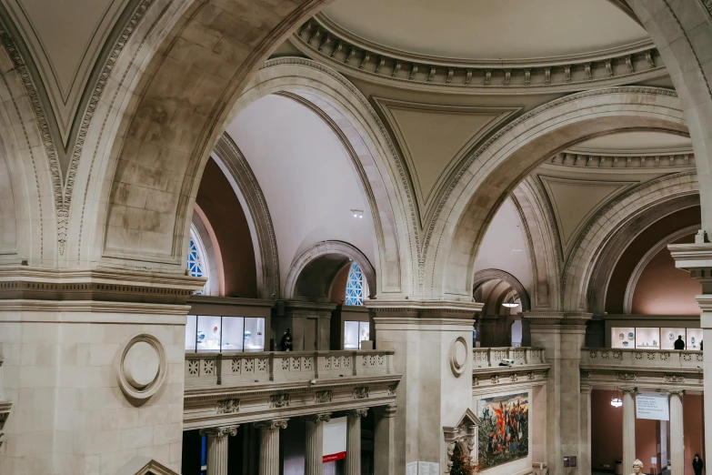 a couple of people that are standing in a building, a marble sculpture, inspired by Thomas Struth, trending on unsplash, high arched ceiling, met gala, victorian arcs of sand, architectural digest photo