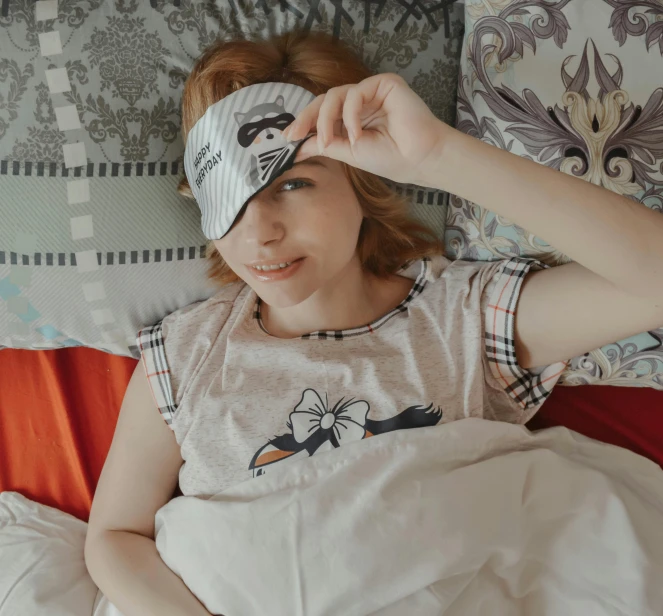 a woman laying in bed wearing a sleep mask, a cartoon, trending on pexels, wearing a shirt, anna nikonova aka newmilky, bird's eye, fan favorite