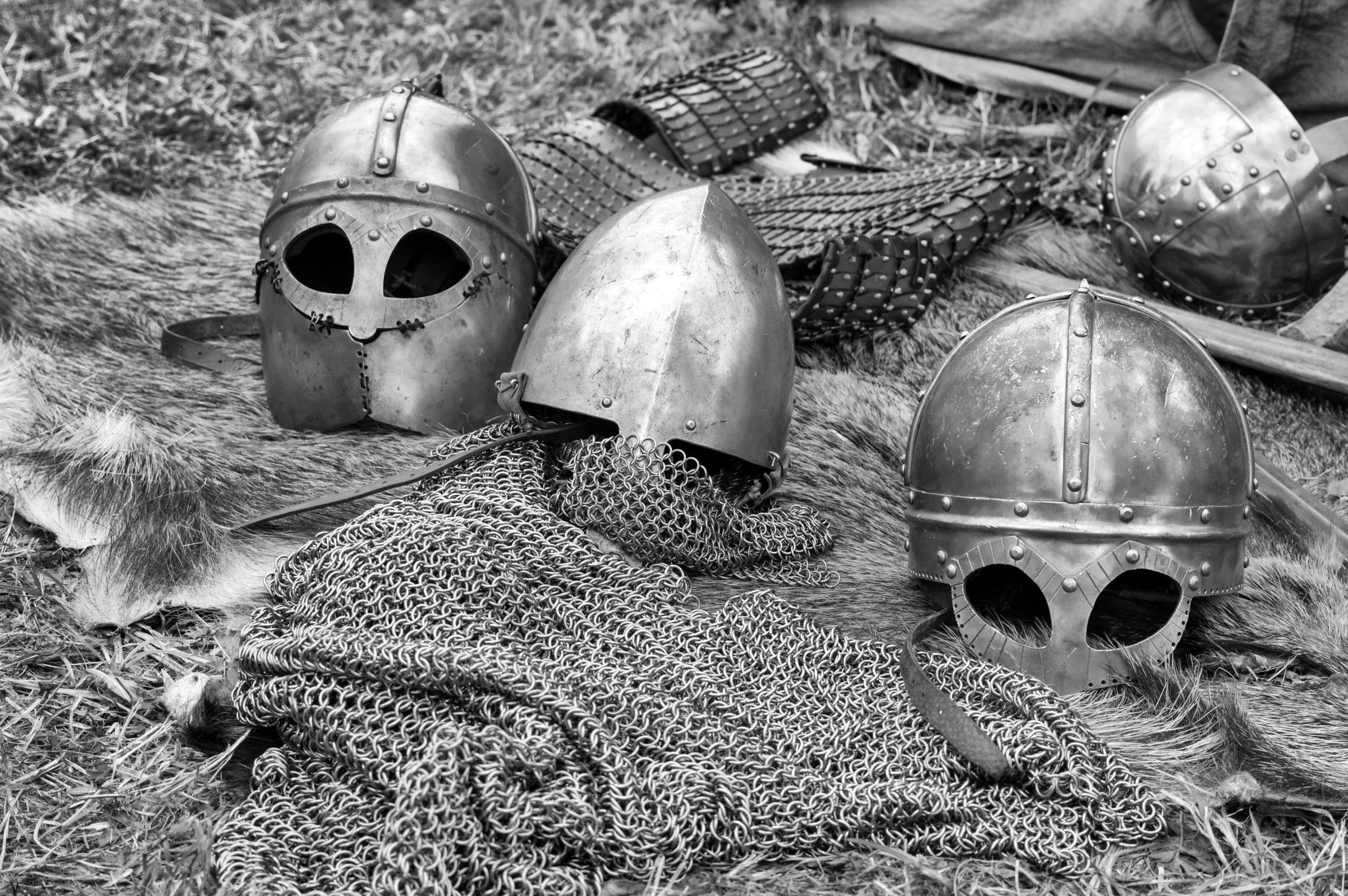 a couple of helmets sitting on top of a pile of fur, a black and white photo, pixabay, renaissance, chainmail, on the battlefield, medieval poster, lamellar armor