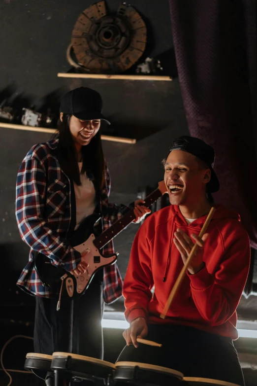 a couple of people that are playing musical instruments, hat and hoodie, epk, smileing nright, cut-scene