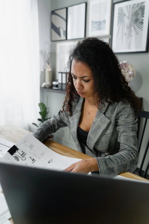 a woman sitting at a table in front of a laptop computer, on high-quality paper, curated collections, profile image, ariel perez