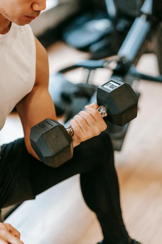 a man sitting on a bench with a pair of dumbbells, pexels contest winner, renaissance, hexagonal shaped, closeup of arms, emily rajtkowski, fast movement