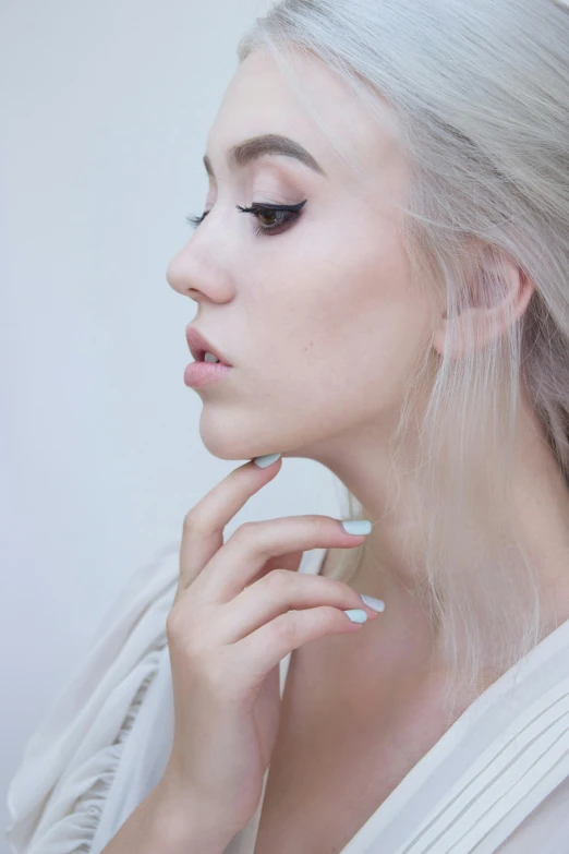 a woman with white hair is posing for a picture, inspired by Elsa Bleda, trending on pexels, hand on her chin, ariana grande photography, soft portrait shot 8 k, porcelain skin ”