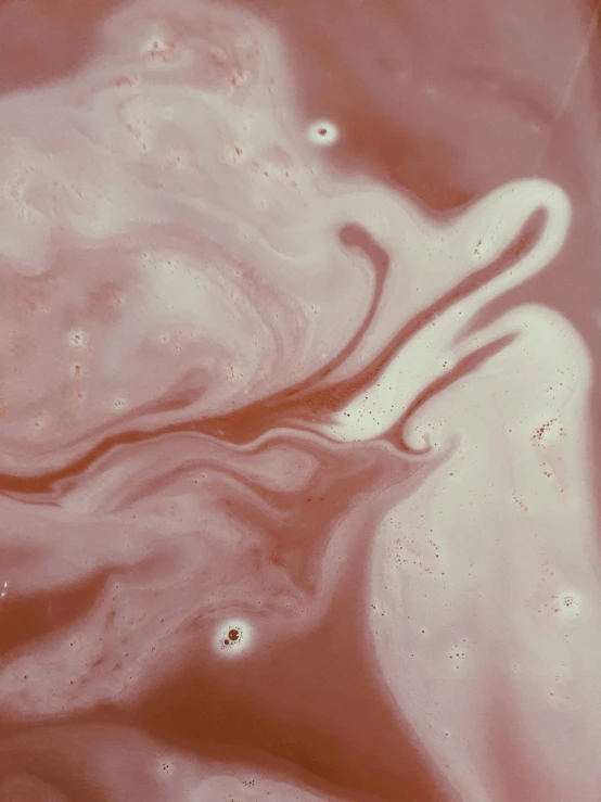 a close up of a bowl of liquid with a spoon in it, inspired by Anna Füssli, trending on unsplash, generative art, covered in pink flesh, red swirls, her face is coated in a whitish, ethereal eel