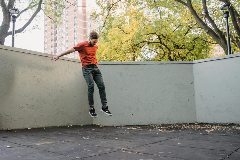 a man flying through the air while riding a skateboard, inspired by William Berra, pexels contest winner, realism, high walls, jump pose, thin young male, autumnal