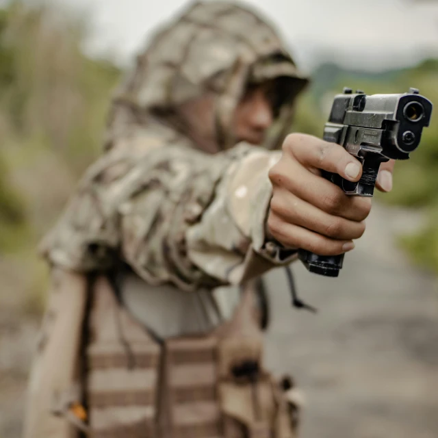 a close up of a person holding a gun, military-grade, small, game ready, picture