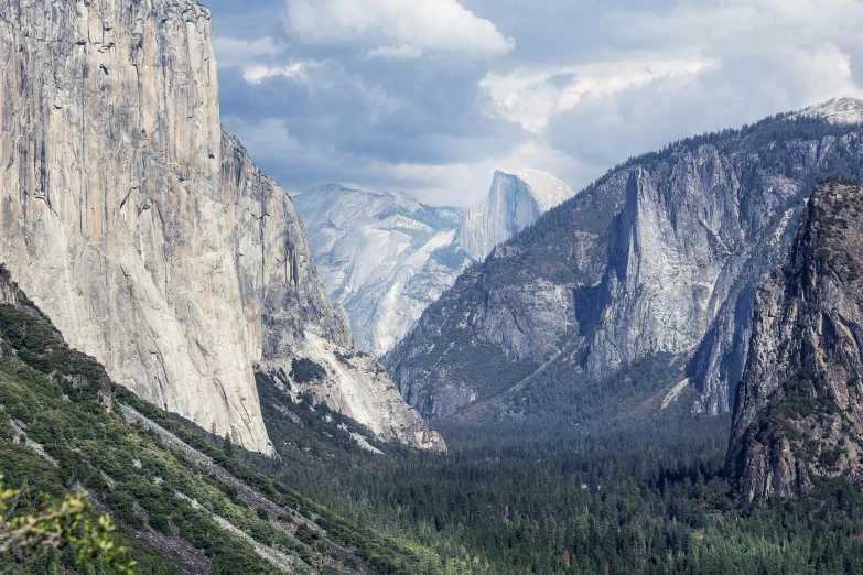 a view of a valley with mountains in the background, by Kristin Nelson, pexels contest winner, el capitan, tall stone spires, slide show, extreme panoramic