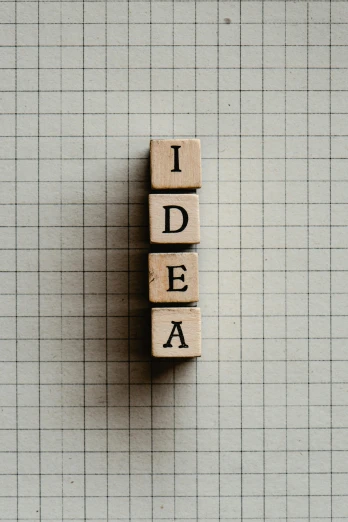 a wooden block with the word idea written on it, by Konrad Witz, trending on unsplash, visual art, grid layout, square shapes, patent, 15081959 21121991 01012000 4k