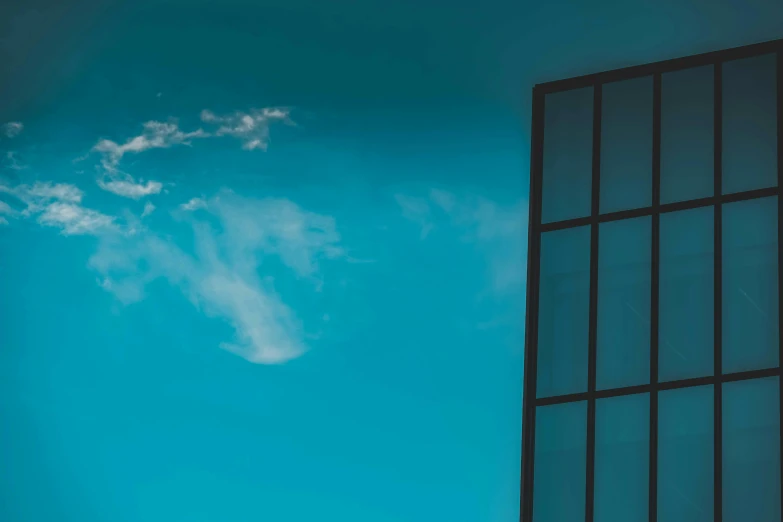 a jetliner flying through a blue sky next to a tall building, inspired by Richard Wilson, pexels contest winner, minimalism, photo of a beautiful window, painted metal and glass, cloud in the sky, stacked image