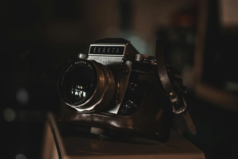 a camera sitting on top of a wooden table, a picture, captured in low light, hasselblad medium format, vintage aesthetic, picture