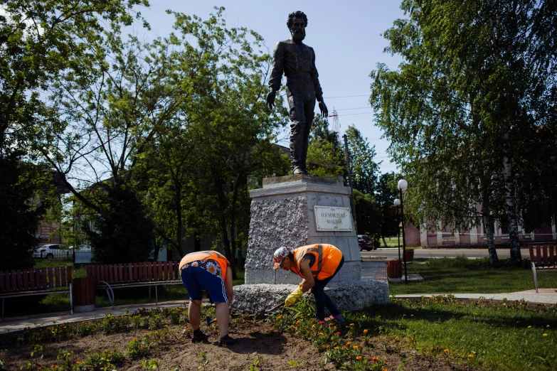 a couple of men working on a statue, pulling weeds out frantically, gintas galvanauskas, 🚿🗝📝