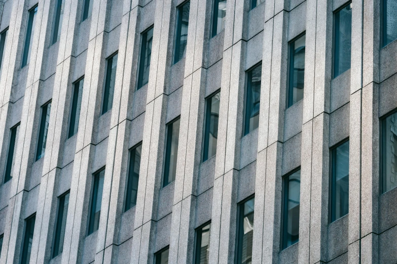 a close up of a building with many windows, inspired by David Chipperfield, pexels contest winner, gray concrete, square lines, commercial photograph, grey