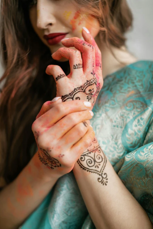 a woman with henna painted on her hands, trending on pexels, renaissance, square, medium poly, asian woman, blurred