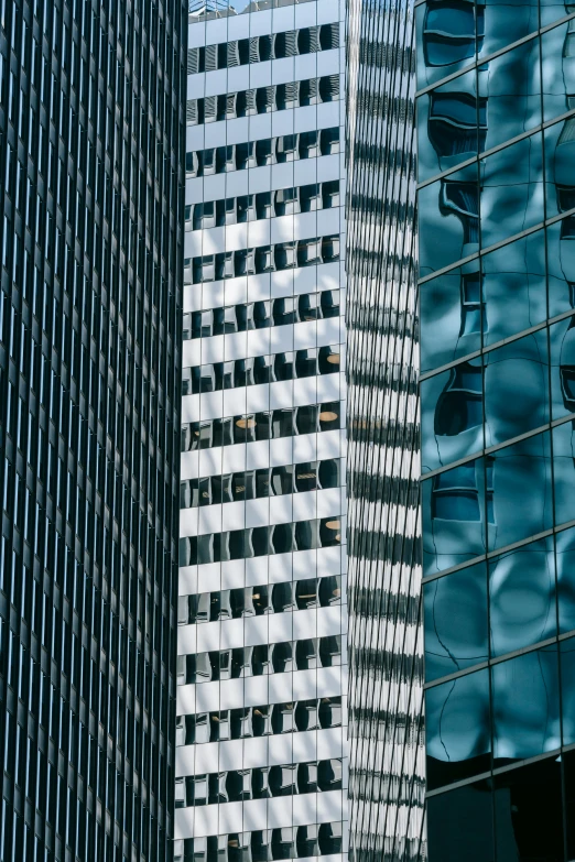 a couple of tall buildings next to each other, a picture, inspired by Ned M. Seidler, pexels contest winner, reflections and refraction, square lines, telephoto shot, three views