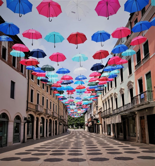 a street filled with lots of colorful umbrellas, an album cover, unsplash contest winner, street art, indigo and venetian red, squares, empty streetscapes, polka dot