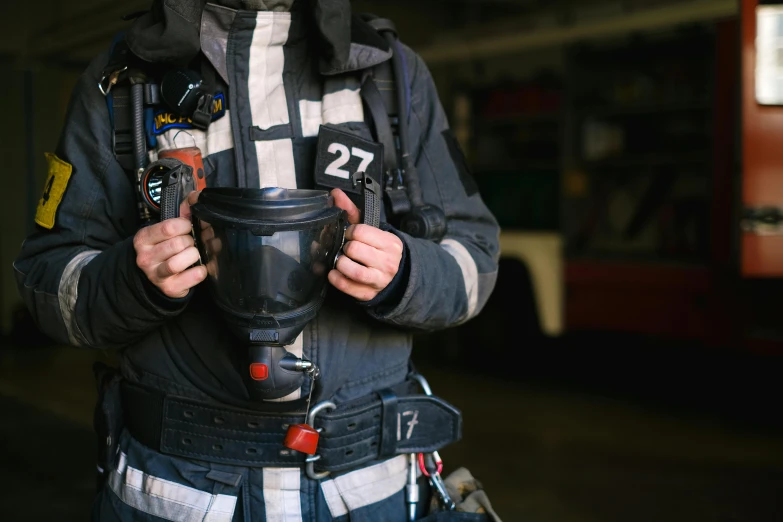 a close up of a person wearing a helmet, a picture, firefighting gear, holding flask in hand, shot on sony a 7, rectangle