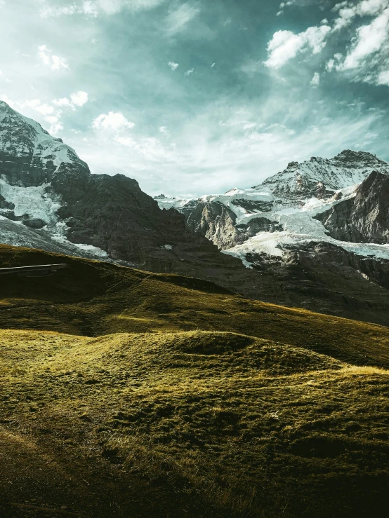 a train traveling through a lush green hillside, a matte painting, by Matthias Weischer, pexels contest winner, icy glaciers, alessio albi, distant mountains lights photo