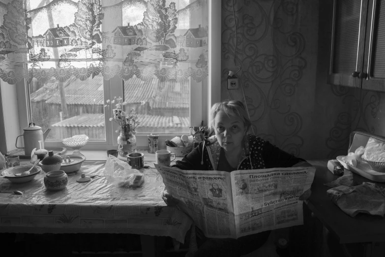 a woman sitting at a table reading a newspaper, a black and white photo, by Sergei Sviatchenko, family dinner, bright morning, square, lpoty