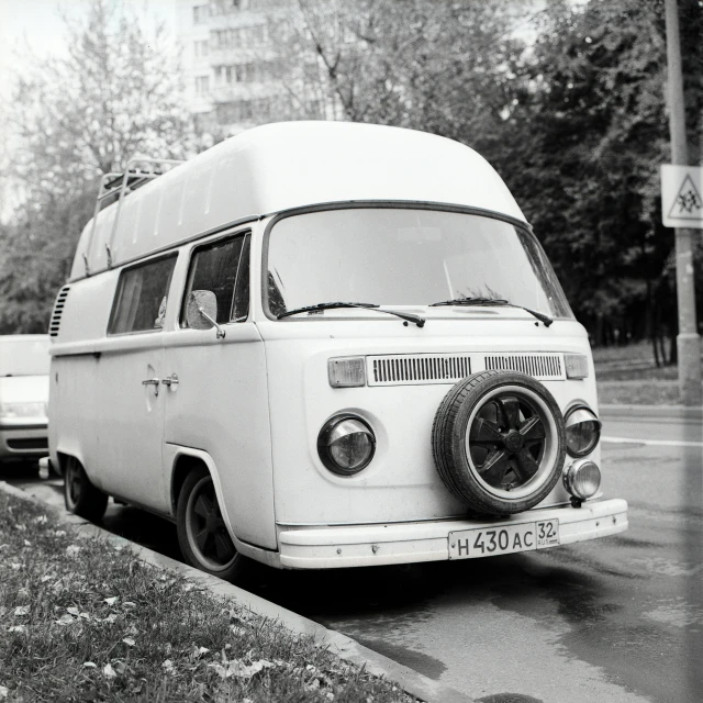 a white van parked on the side of the road, a black and white photo, 000 — википедия, huge-eyed, hippy, vintage camera