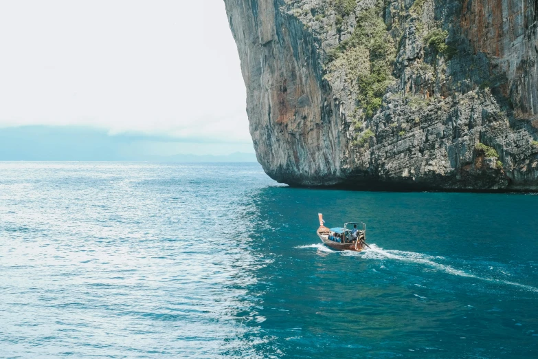 a couple of people riding on the back of a boat, pexels contest winner, sheer cliffs surround the scene, avatar image, thailand, thumbnail