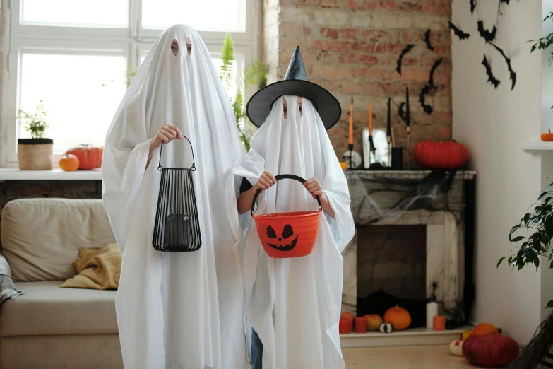 a couple of people in costumes standing next to each other, by Elaine Hamilton, pexels, children born as ghosts, buckethead, at home, gif