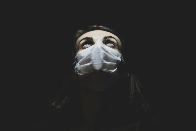 a woman wearing a face mask in the dark, pexels contest winner, head looking up, on a gray background, contaminated, instagram picture