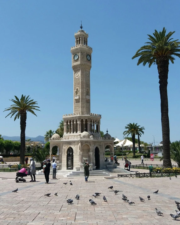 a clock tower in the middle of a plaza surrounded by palm trees, inspired by Serafino De Tivoli, pamukkale, port, city views, profile image