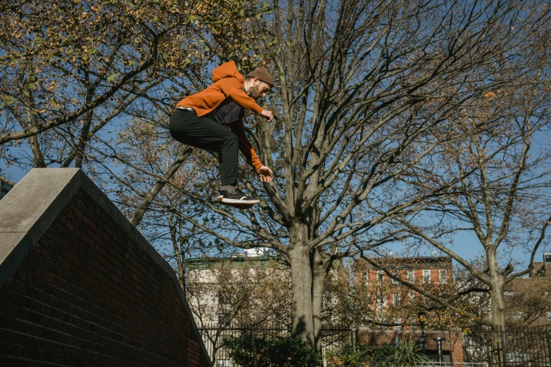 a man flying through the air while riding a skateboard, by Neil Boyle, unsplash, sitting on a tree, bricks flying, low quality photo, thumbnail