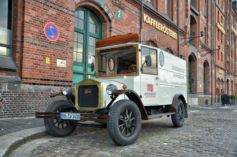 an old truck parked in front of a brick building, by Harry Haenigsen, pexels contest winner, art nouveau, square, white, beer, 8k restored and remastered