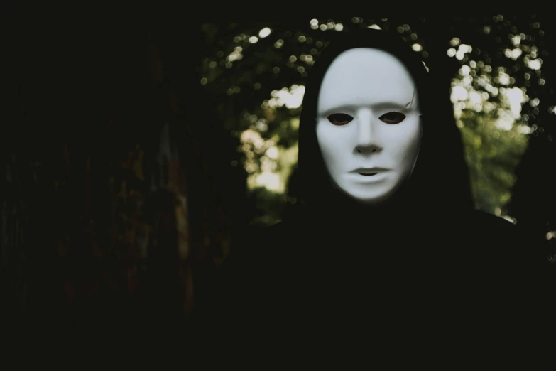 a person wearing a white mask in the dark, inspired by Nicola Samori, pexels contest winner, slenderman in the woods, blank faces, pale white face, album cover