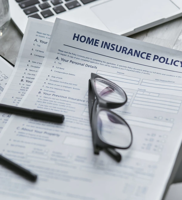 a laptop computer sitting on top of a desk next to a pair of glasses, shutterstock, selling insurance, home display, covered in