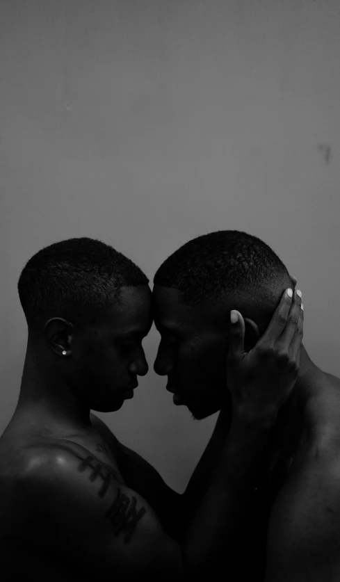 a man and a woman standing next to each other, an album cover, by Terrell James, two men hugging, charcoal color skin, pride, twins