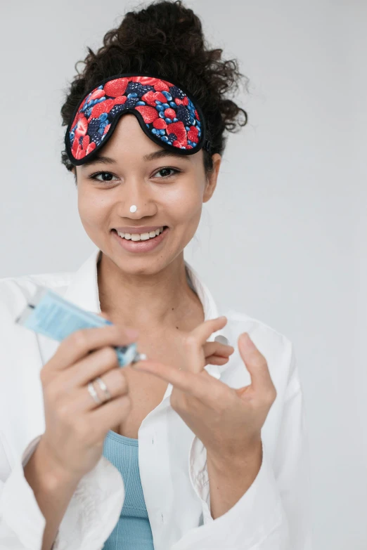 a woman holding a toothbrush in one hand and a toothpaste in the other, by Matija Jama, pexels contest winner, made of lab tissue, happy fashion model, mixed race, wearing goggles