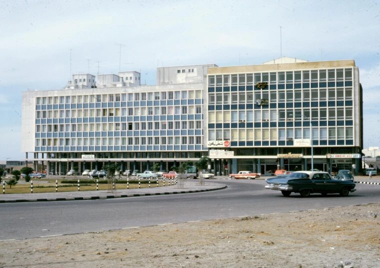 a large building sitting on the side of a road, a colorized photo, brutalism, iraq nadar, getty images, city square, terminal