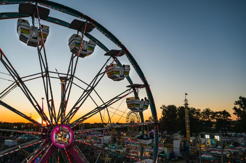 a ferris wheel at a fair at sunset, by Dan Frazier, pexels contest winner, avatar image, high above the ground, sitting down, panoramic shot