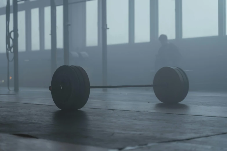 a couple of wheels sitting on top of a wooden floor, by Attila Meszlenyi, carrying two barbells, hazy atmosphere, 2 0 2 1 cinematic 4 k framegrab, unsplash contest winning photo