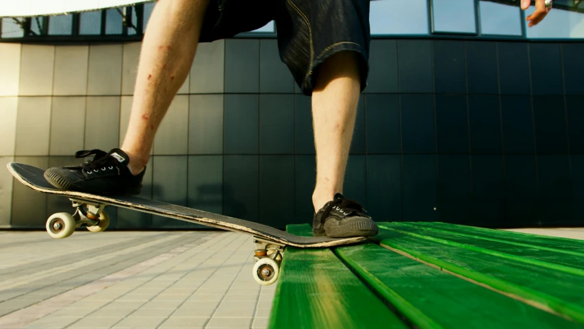 a man riding a skateboard on top of a green bench, pexels contest winner, scratched, legs taking your pov, panels, on a rooftop