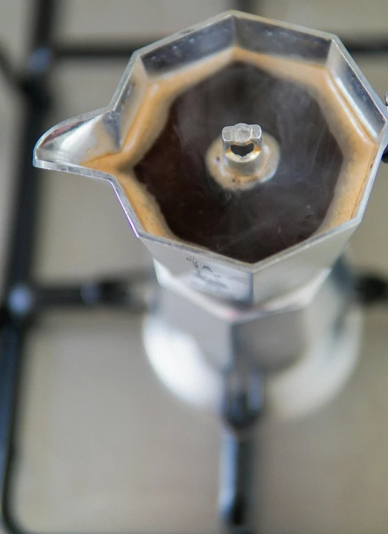 a coffee maker sitting on top of a stove, a portrait, inspired by Géza Dósa, unsplash, macro up view metallic, moroccan, version 3, made of glazed