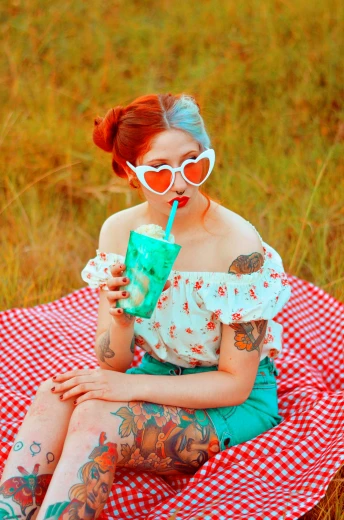 a woman sitting on top of a red and white checkered blanket, inspired by Elsa Bleda, trending on pexels, pop art, drink milkshakes together, teal hair, ( redhead, photograph of a sleeve tattoo