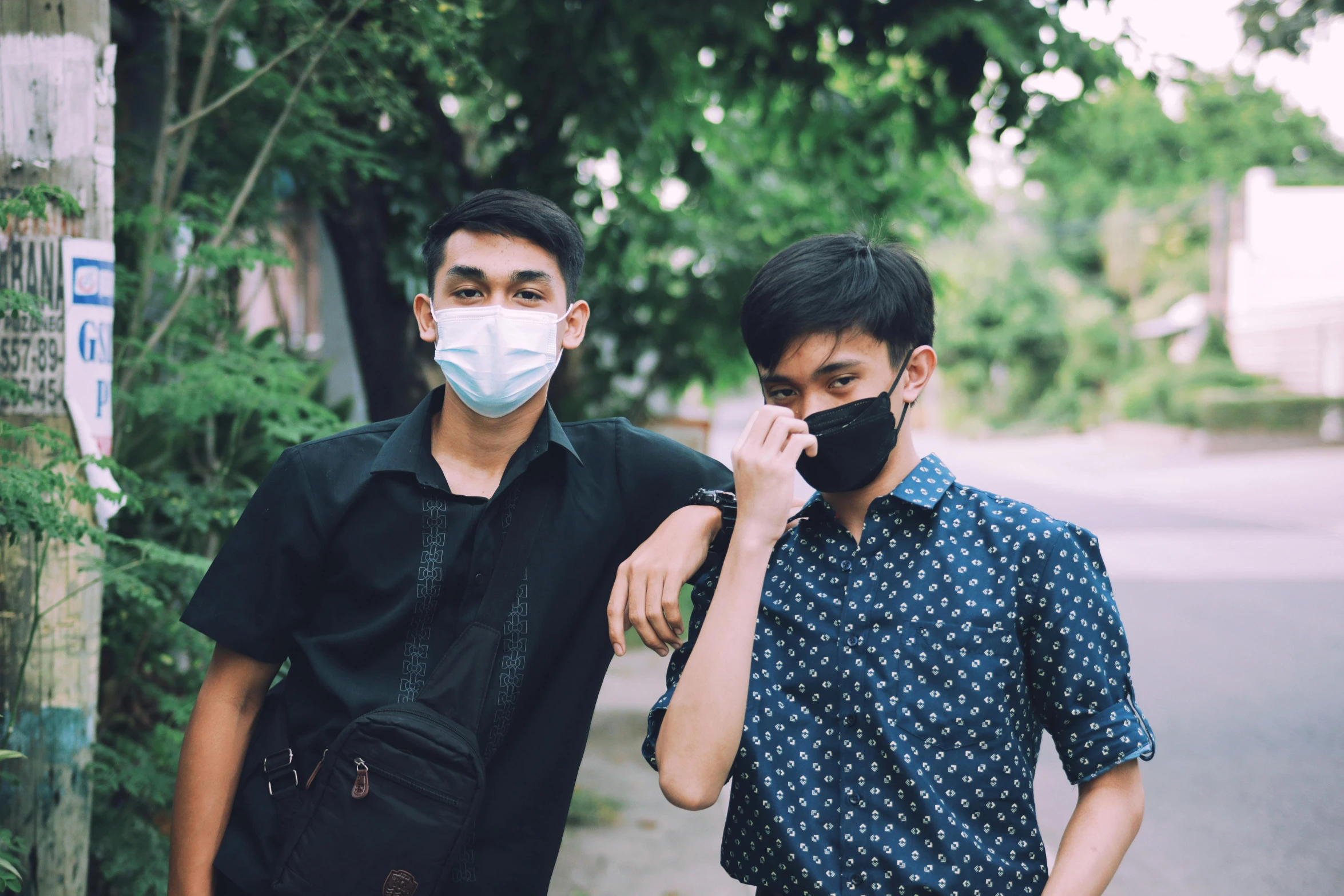 a couple of men standing next to each other on a street, trending on pexels, surgical mask covering mouth, ruan jia and brom, cute boys, avatar image