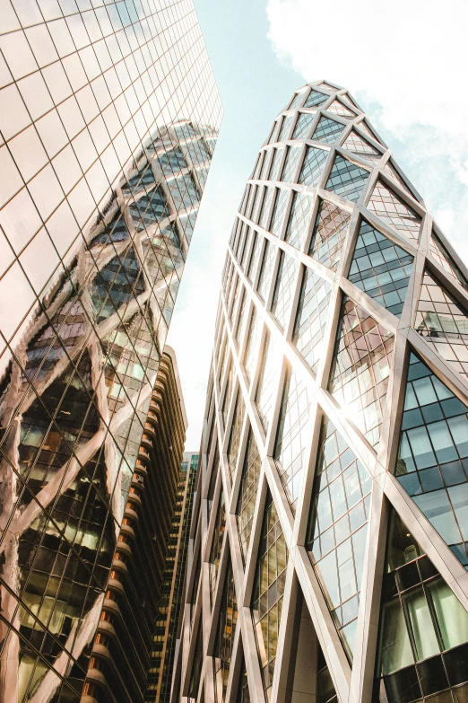 a couple of tall buildings next to each other, inspired by Zaha Hadid, pexels contest winner, square, faceted, an ancient, gold