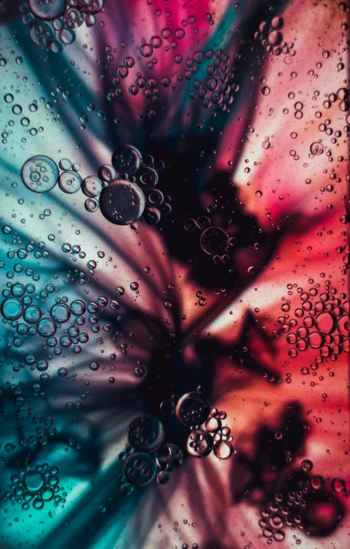 a close up of water bubbles on a cell phone, a microscopic photo, unsplash, art photography, tie-dye, portrait photo, red and cyan ink, made of liquid