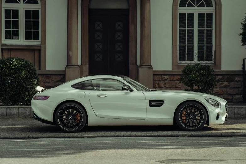 a white mercedes sports car parked in front of a building, inspired by Harry Haenigsen, pexels contest winner, photorealism, side profile view, shot on sony a 7, rectangle, white on black
